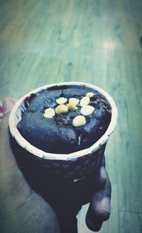 Close-up of hand holding ice cream in bowl