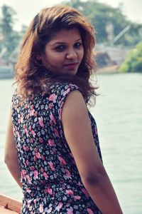 Portrait of beautiful young woman standing outdoors