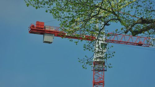 Low angle view of ferris wheel against clear blue sky