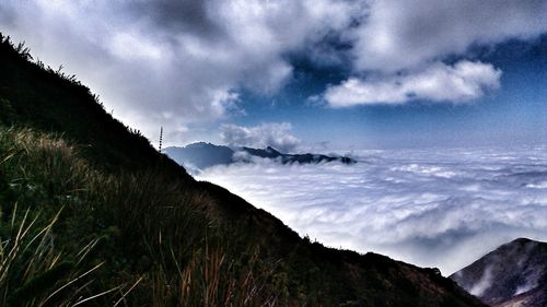 View of snowcapped mountain against cloudy sky