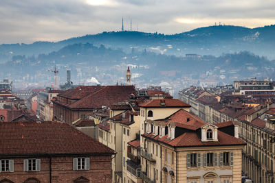 High angle view of buildings in town against sky