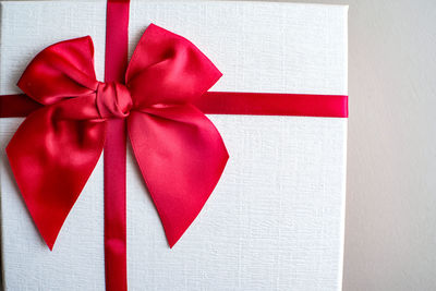 Close-up of red umbrella on white wall