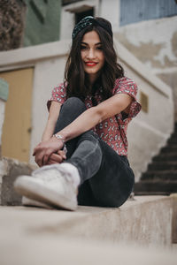 Portrait of woman sitting outdoors