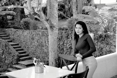 Portrait of young woman standing outdoors