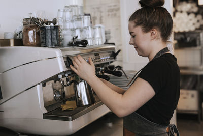 Side view of woman holding coffee cup