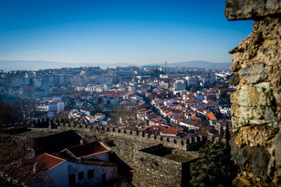 High angle view of cityscape against blue sky