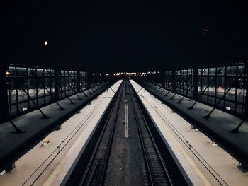 Empty railroad station platform at night