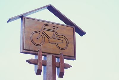Low angle view of road sign against clear sky