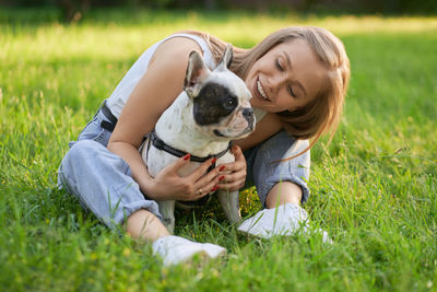 Woman with dog on field