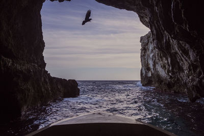 Scenic view of sea and rock formation against sky