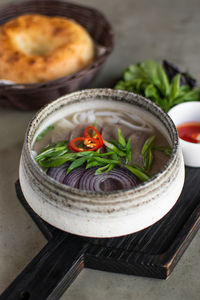 Vietnamese soup pho bo with beef on a gray background