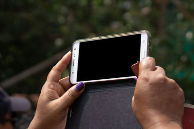 Midsection of man using mobile phone