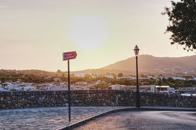 Street by mountain against sky