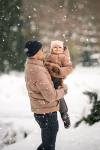 Portrait of boy standing on snow