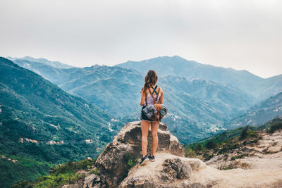 People on mountain against sky