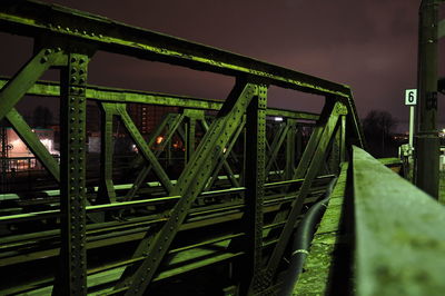 Low angle view of illuminated bridge against sky at night