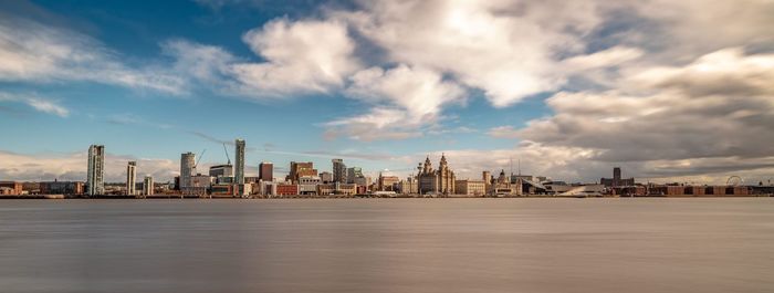 Panoramic view of sea and buildings against sky