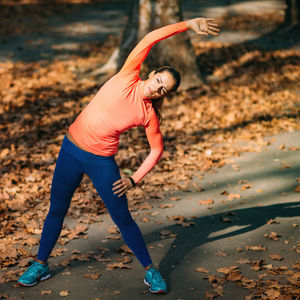 Woman stretching in the park after jogging.