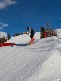 Full length of man skiing on snow covered mountain