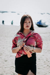 Young woman standing on beach