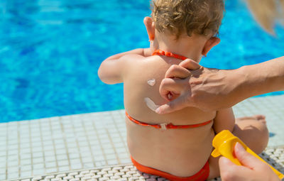 Side view of girl playing with soap