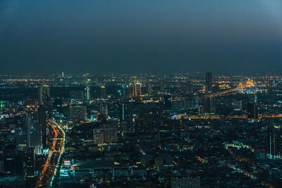 High angle view of illuminated city buildings at night