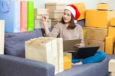 Young woman sitting on sofa in box