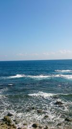 Scenic view of sea against clear blue sky