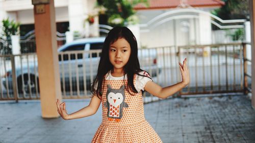 Portrait of young woman standing outdoors