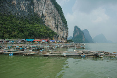 Scenic view of sea and mountains against sky