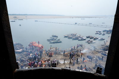 High angle view of crowd at beach against sky