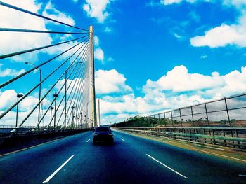 View of bridge against cloudy sky