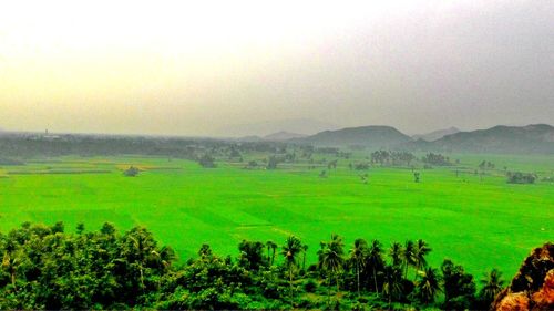 Scenic view of landscape against cloudy sky