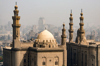 Buildings in city against sky