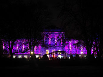 Illuminated built structure against sky at night