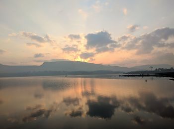 Scenic view of lake against sky during sunset