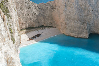 Beautiful view of a deserted beach with a sunken ship.