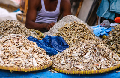 Market vendor selling dried fish in the local market in berastagi, indonesia