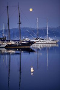 Sailboats in harbor at dusk