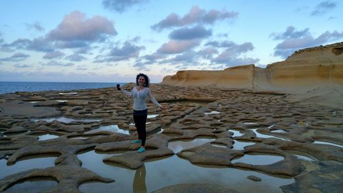 Full length of woman standing on beach