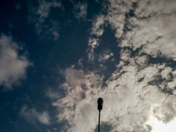 Low angle view of silhouette pole against sky