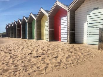 View of beach huts against sky