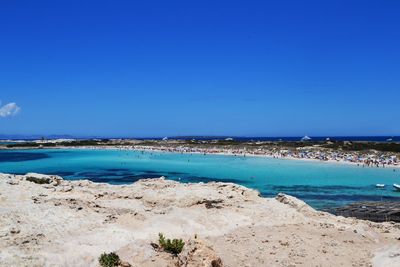 Scenic view of beach against clear blue sky