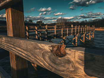 Pier over lake against sky