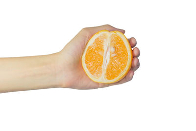 Close-up of hand holding apple against white background