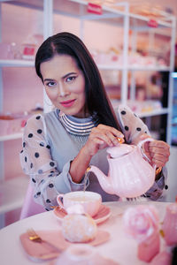 Portrait of smiling woman holding ice cream