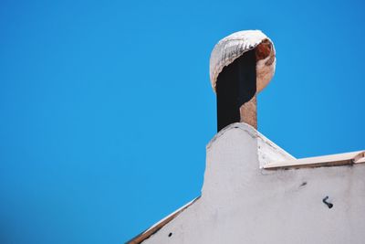 Low angle view of building against clear blue sky