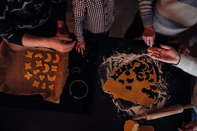 Midsection of family backing cookies