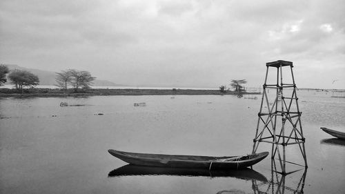 Ship moored on lake against sky