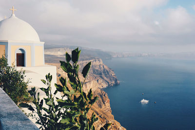 Scenic view of sea and buildings against sky in santorini